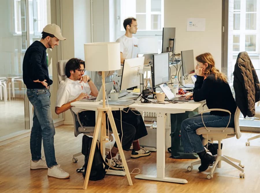 Colleagues working through a problem together at the office